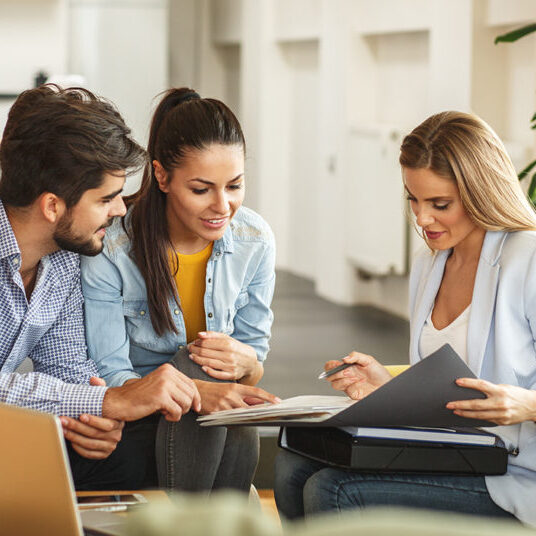 how-to-choose-real-estate-agent-shutterstock_642415924-81bbd4 Female Real Estate agent offer home ownership and life insurance to young couple.